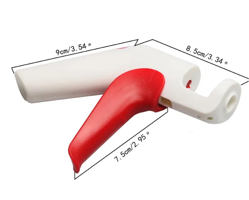Stainless steel manual cherry pitting tool with ergonomic handle on a wooden surface.