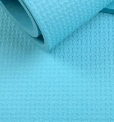 Red EVA fitness yoga mat with 6mm thickness on a wooden floor.