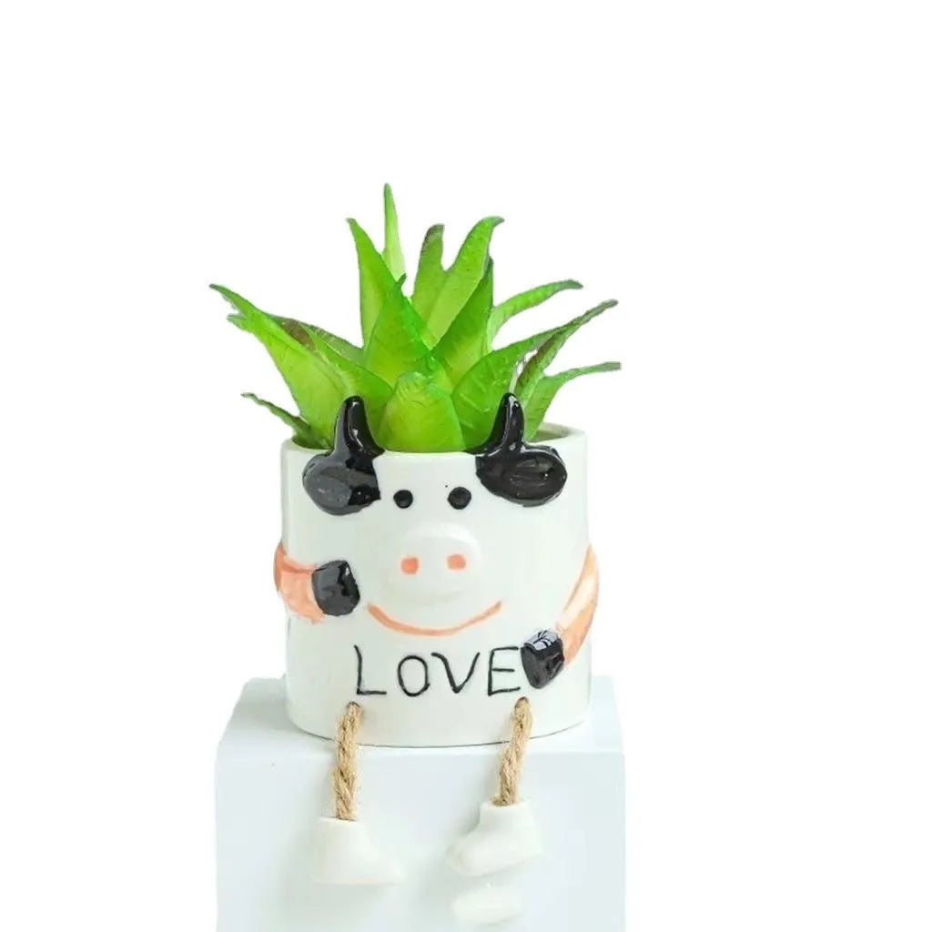 Ceramic hanging foot flowerpot for succulent plants in cartoon design on desktop