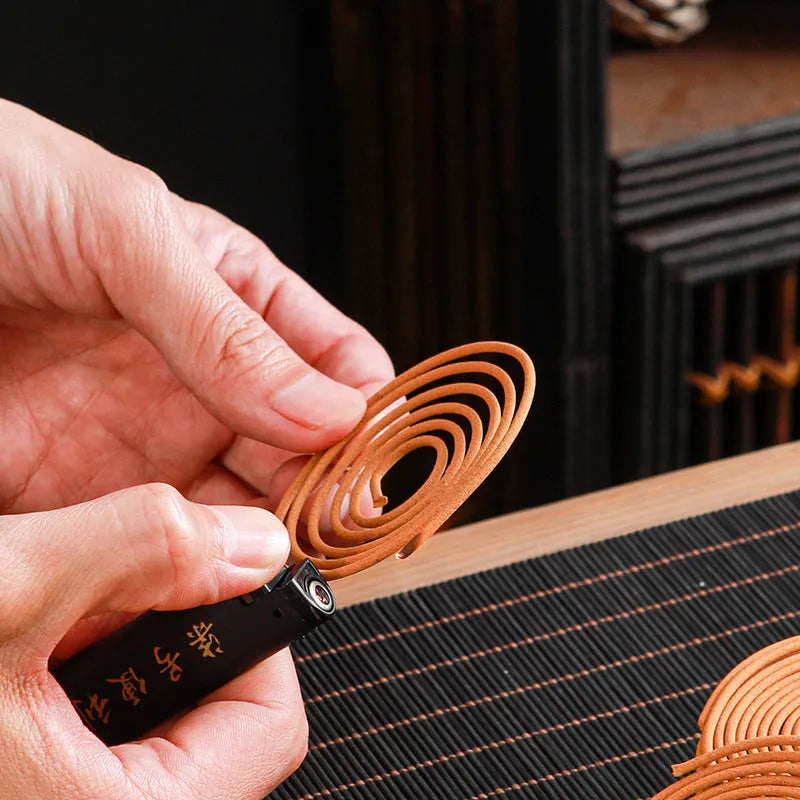 40 small half-handmade incense coils in a chosen fragrance such as sandalwood or agarwood for household use