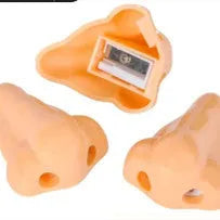 Flesh colour plastic geometry pencil sharpener with big nostril design on a white background.