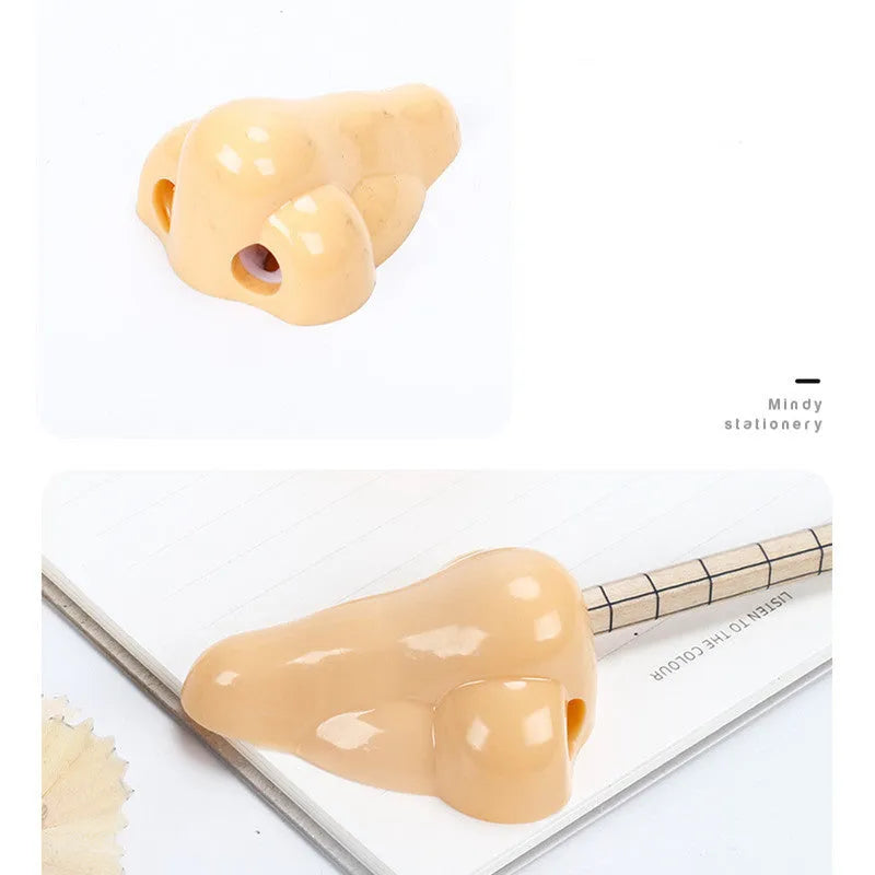 Flesh colour plastic geometry pencil sharpener with big nostril design on a white background.