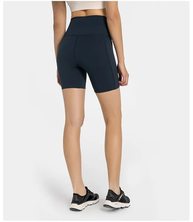 Women's tight-fitting sport shorts in a solid colour, shown on a model for running or gym use.