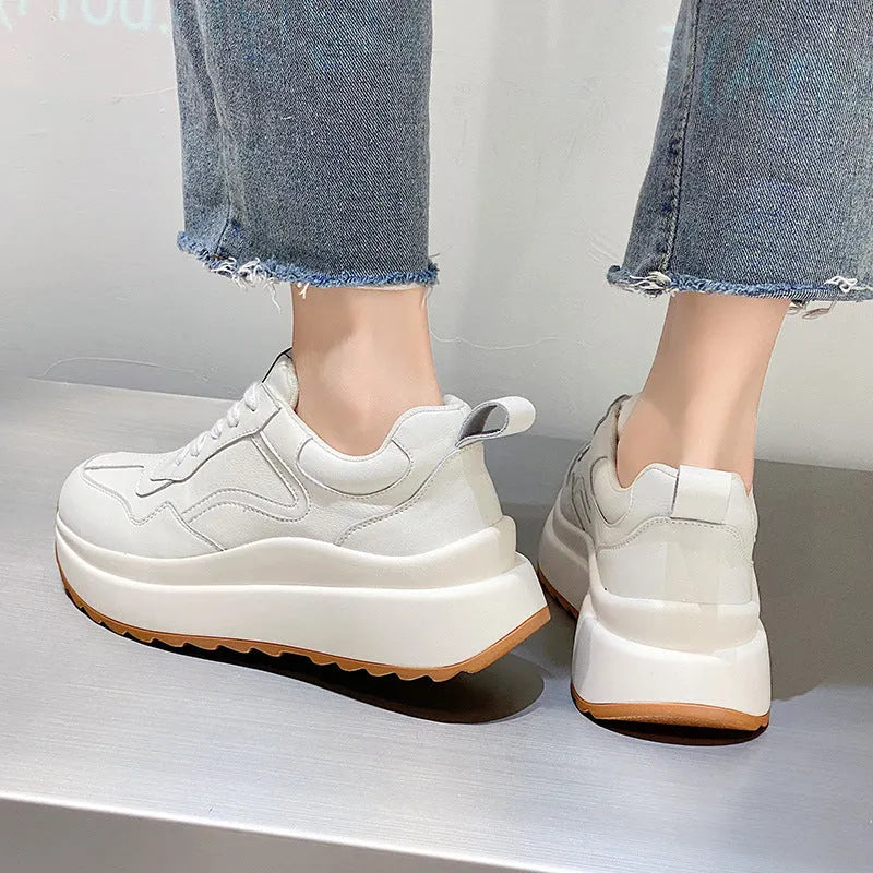 Beige women's low-top lace-up casual shoes with cowhide leather upper and cross strap detail.
