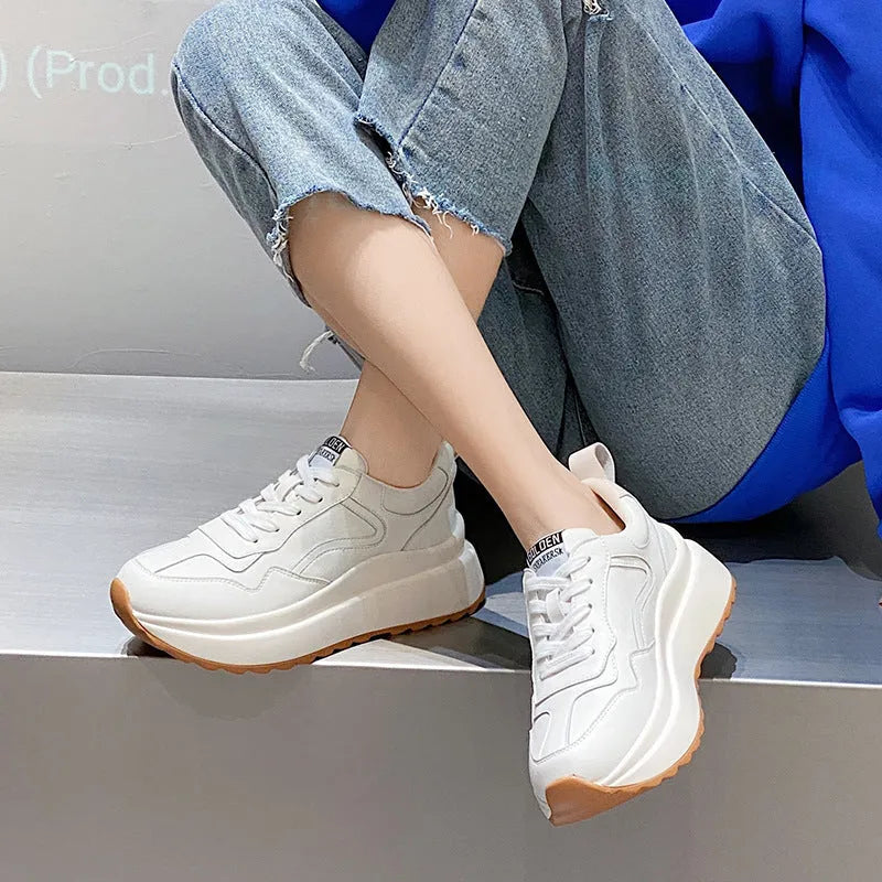 Beige women's low-top lace-up casual shoes with cowhide leather upper and cross strap detail.