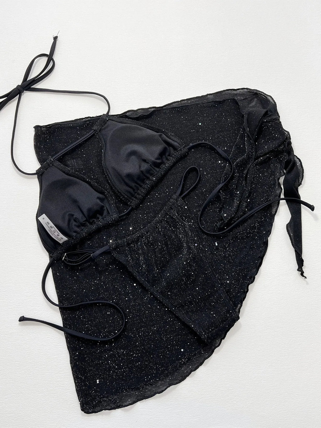 Black three-piece bikini swimsuit set with matching top and shorts