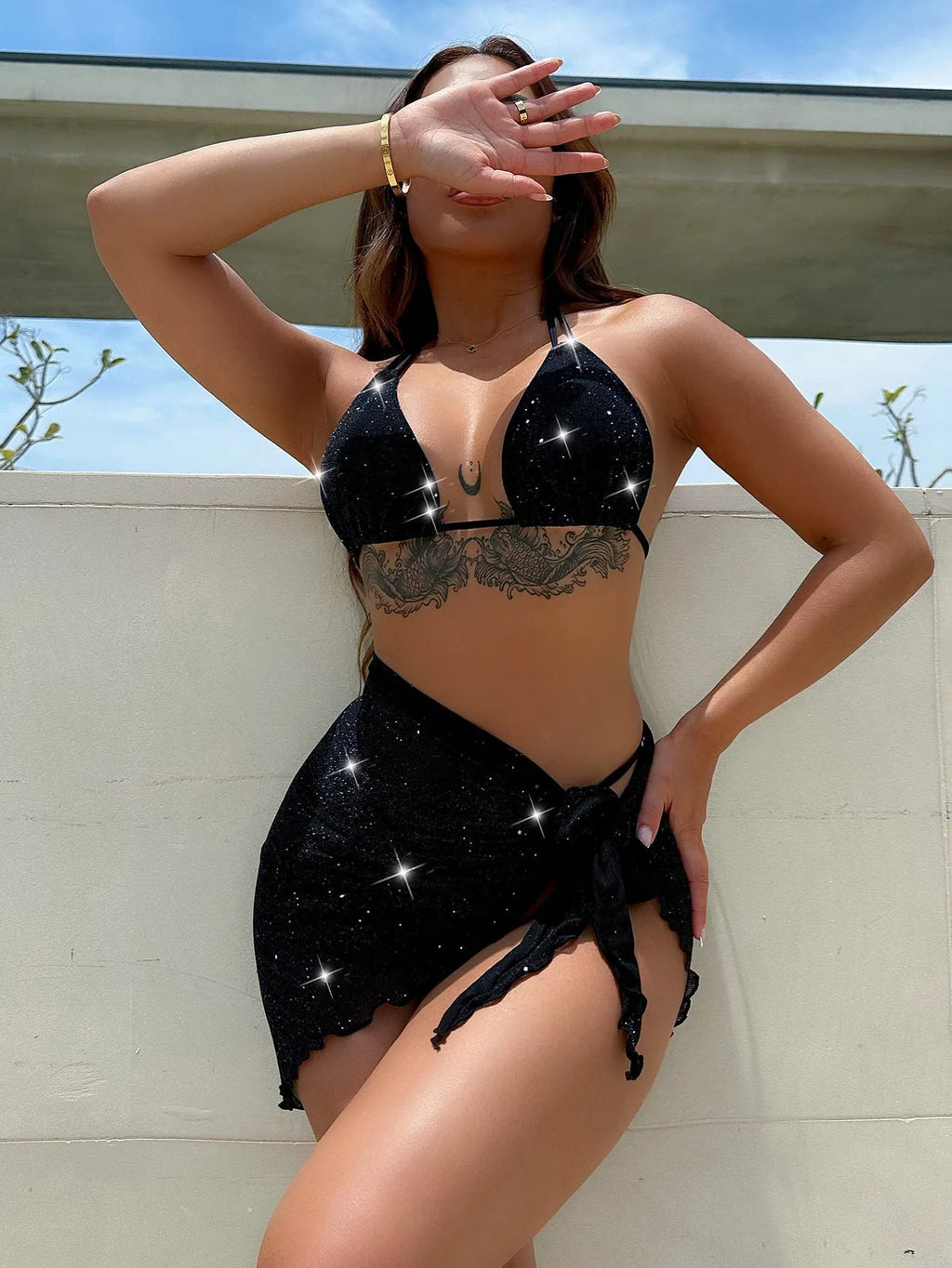 Black three-piece bikini swimsuit set with matching top and shorts