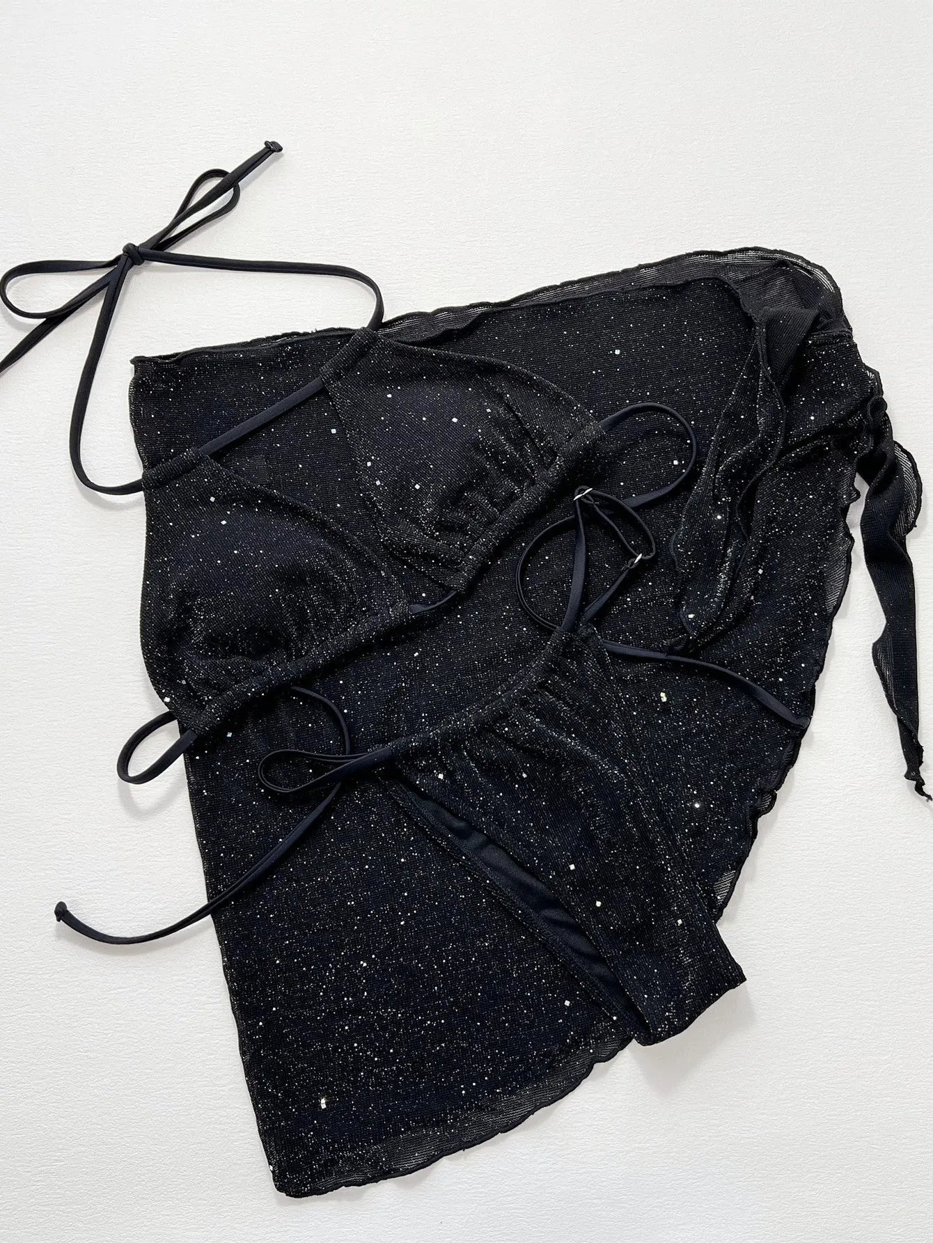 Black three-piece bikini swimsuit set with matching top and shorts