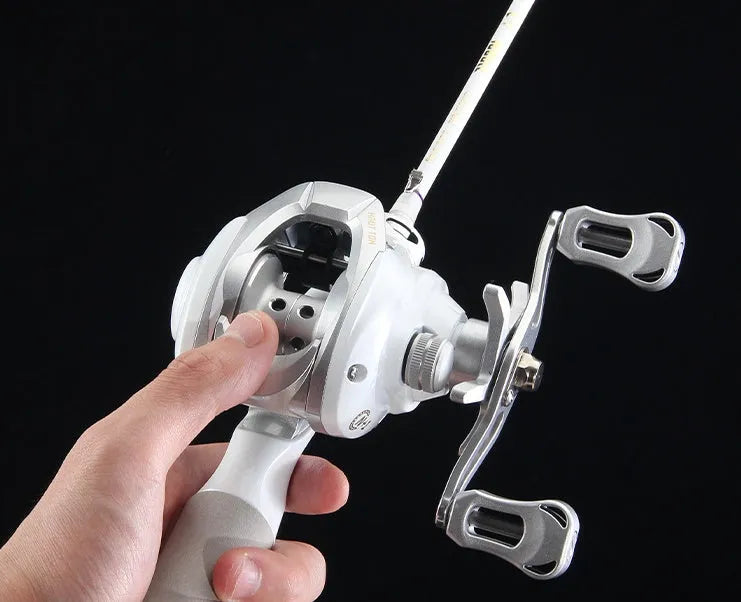 Small white micro baitcasting fishing reel with drip wheel, shown on a neutral background.