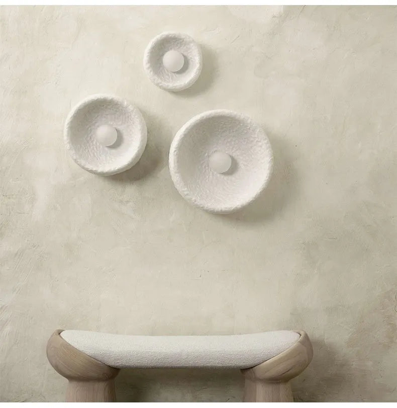 Japanese-style simple silent wall lamp with a white resin shade in three size diameters.
