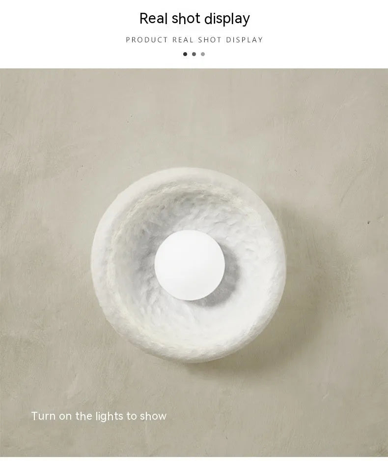 Japanese-style simple silent wall lamp with a white resin shade in three size diameters.