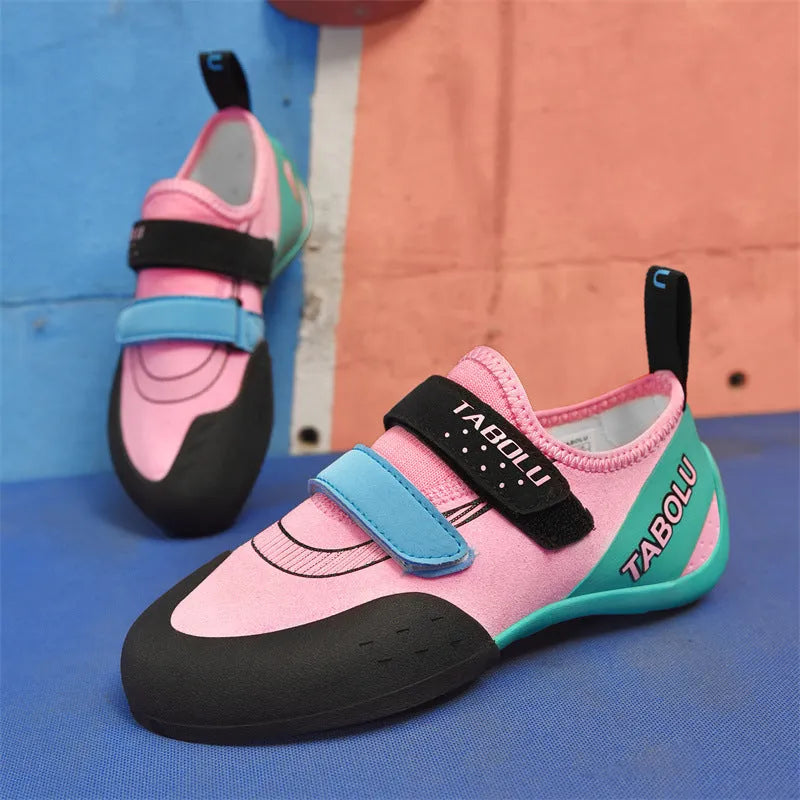 Beginner unisex rock climbing shoes with black and red colourway, showing Velcro strap and rubber sole.