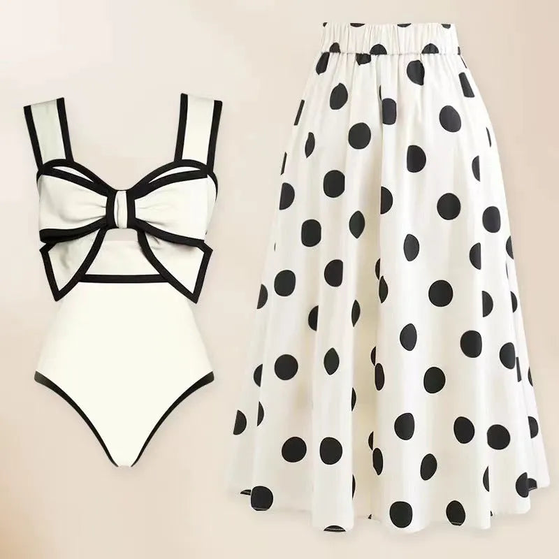 Women's black one-piece swimsuit with white round skirt and bow detail for swimming