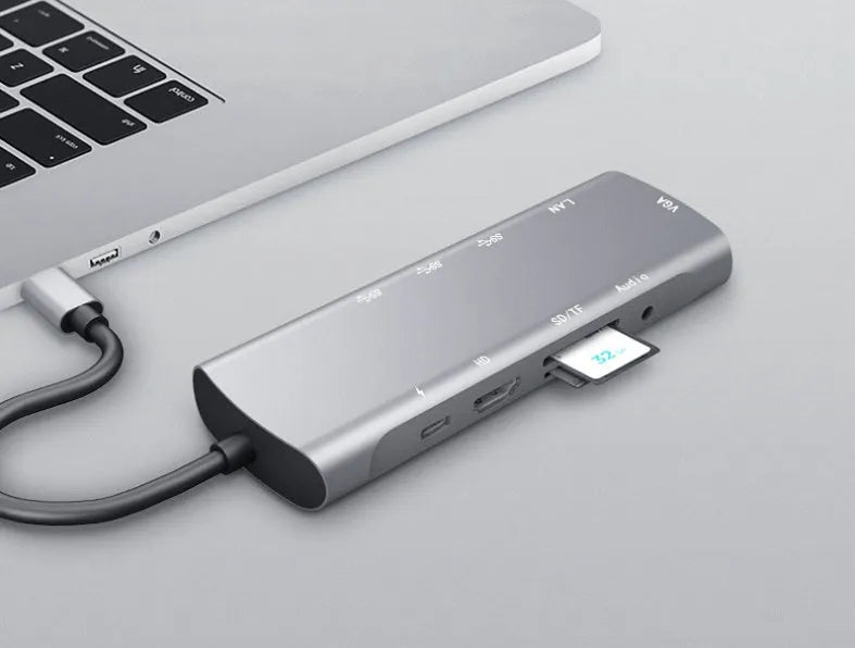 Grey aluminium USB-C docking station with HDMI, VGA, USB ports, and a 140mm cable.
