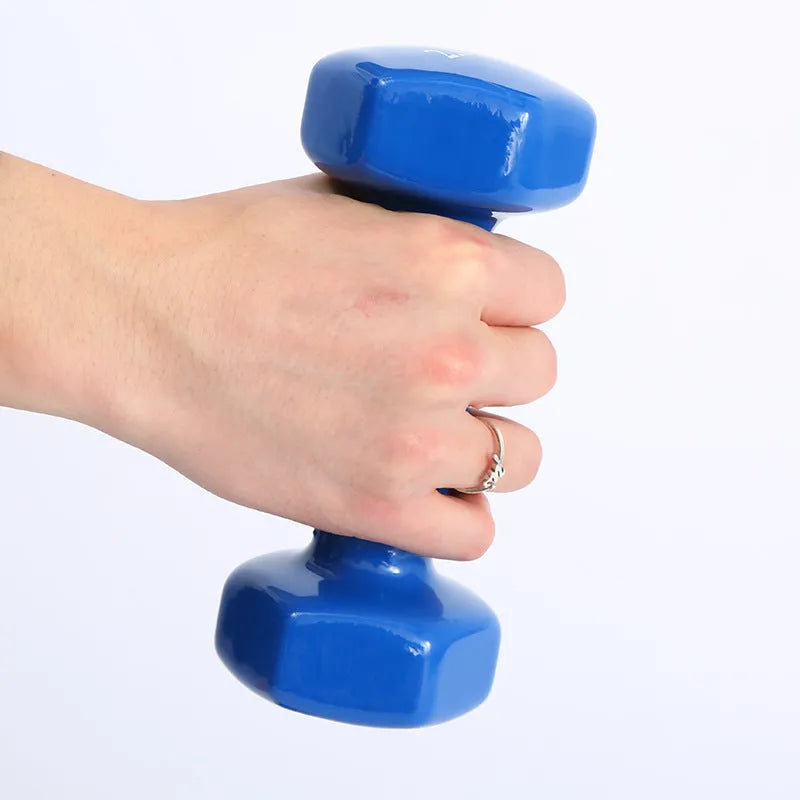 A set of bright colourful plastic dumbbells in different sizes on a light floor.