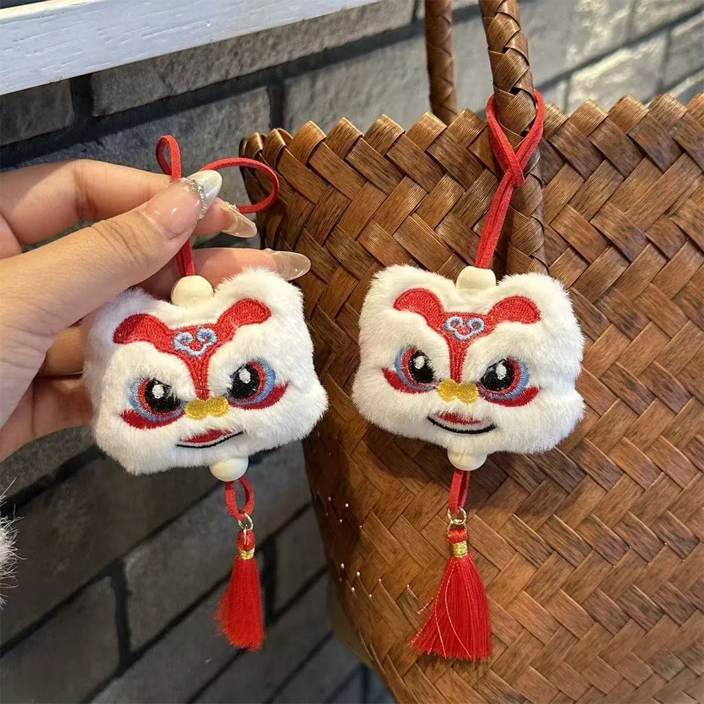 Handmade blue and yellow Chinese style plush lion keychain ornament with tassel and star stone.