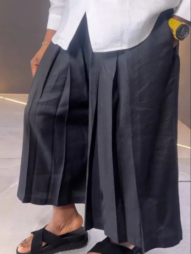 White asymmetric front women's shirt with black pleated trousers casual set