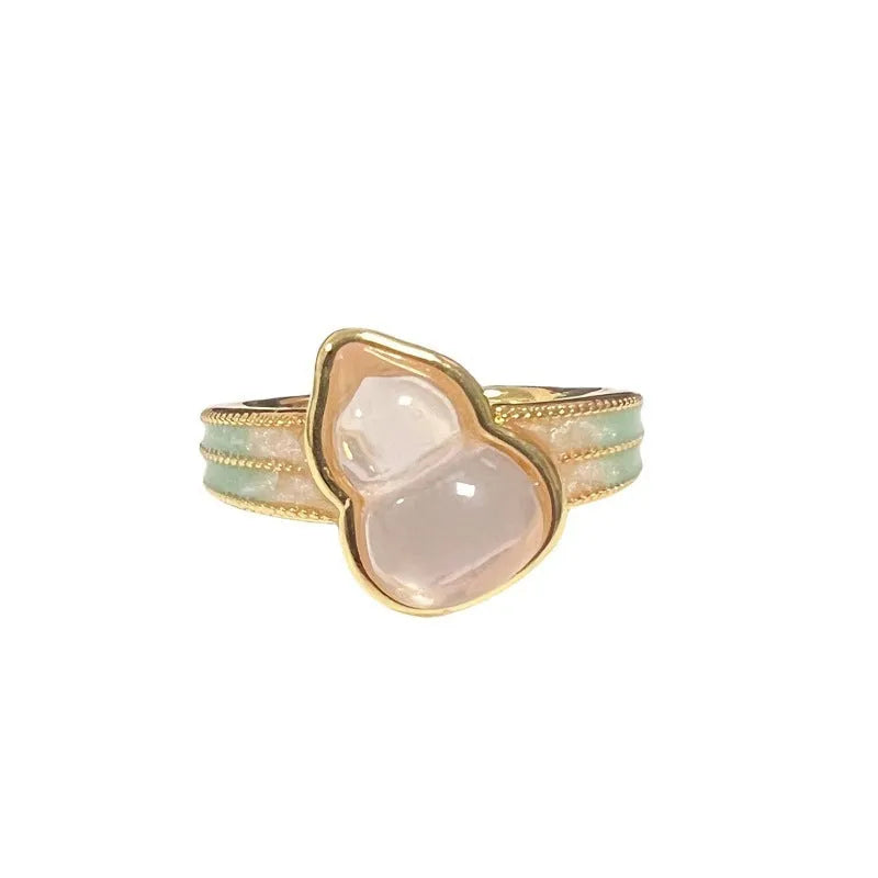 Adjustable copper ring with vintage oil dripping finish showing gourd, flower and bow design with inlaid zircon stones.