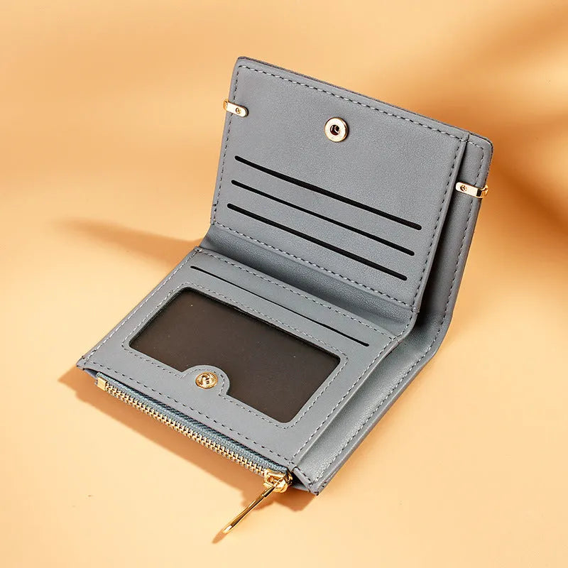 Ladies' black zip-around PU leather wallet open showing multiple card slots and internal compartments.