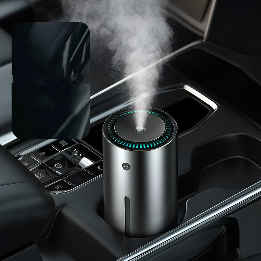 Black aluminium USB car humidifier and essential oil diffuser on a car dashboard.