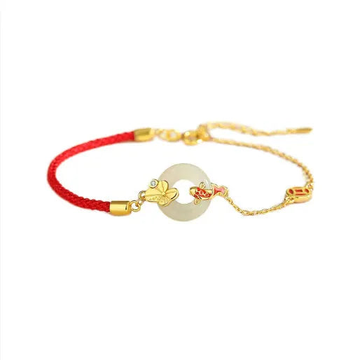 Close-up of a women's retro bracelet with a Hetian Jade stone, red cord, and a gold Koi fish safety buckle on a 925 silver chain.