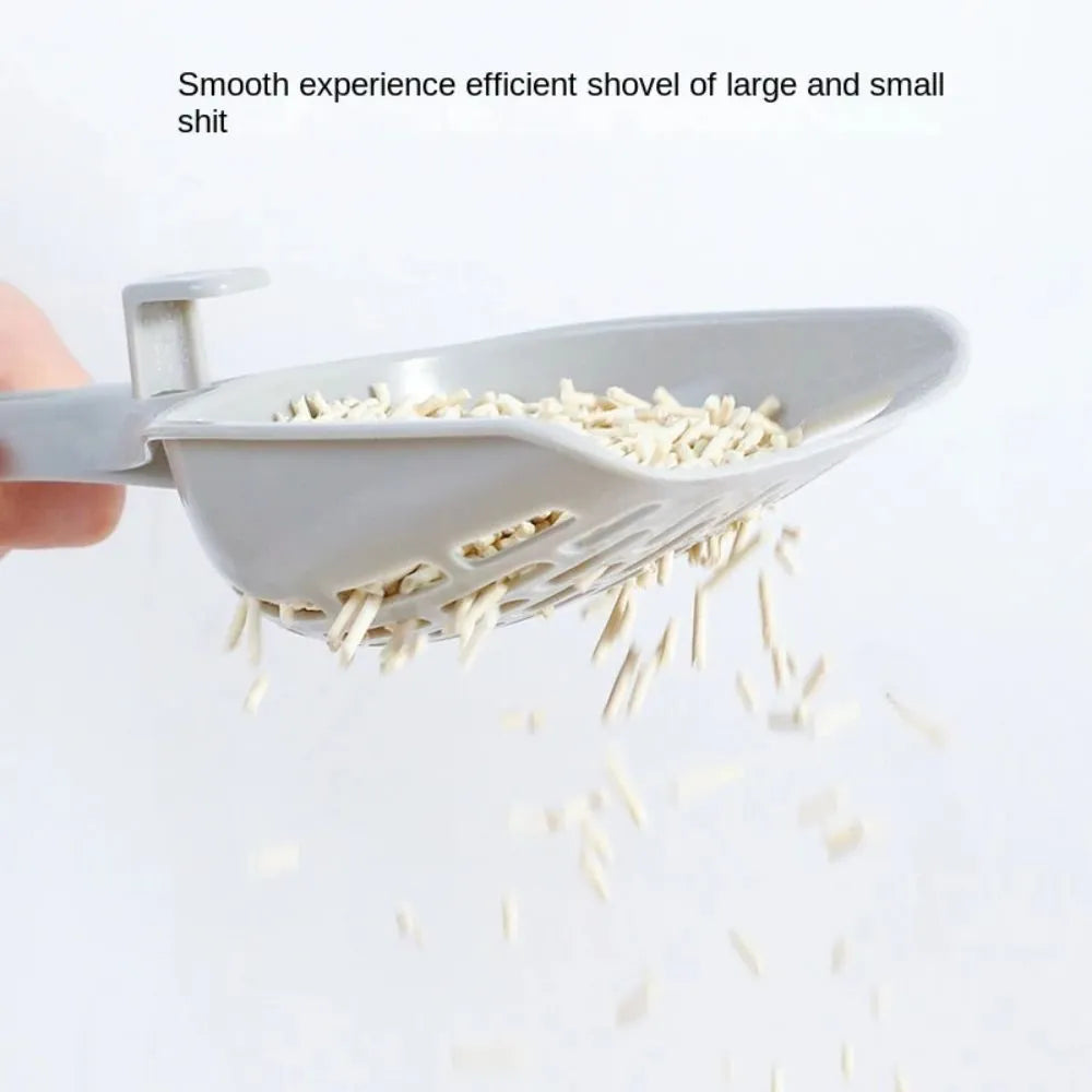 Grey plastic cat litter scoop with an attached base and a handle.