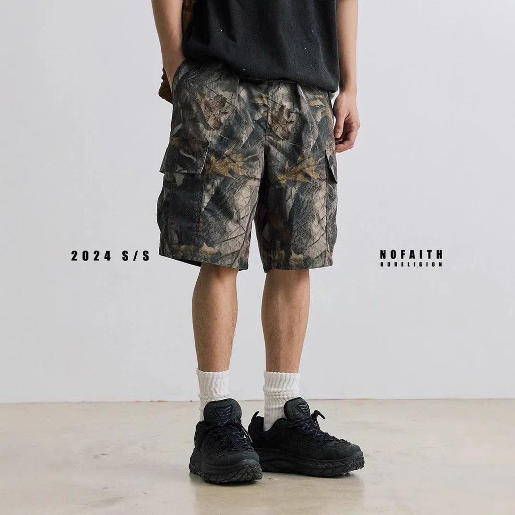 Army green loose fit straight-leg denim shorts with a mid waist and zip fly on a hanger.