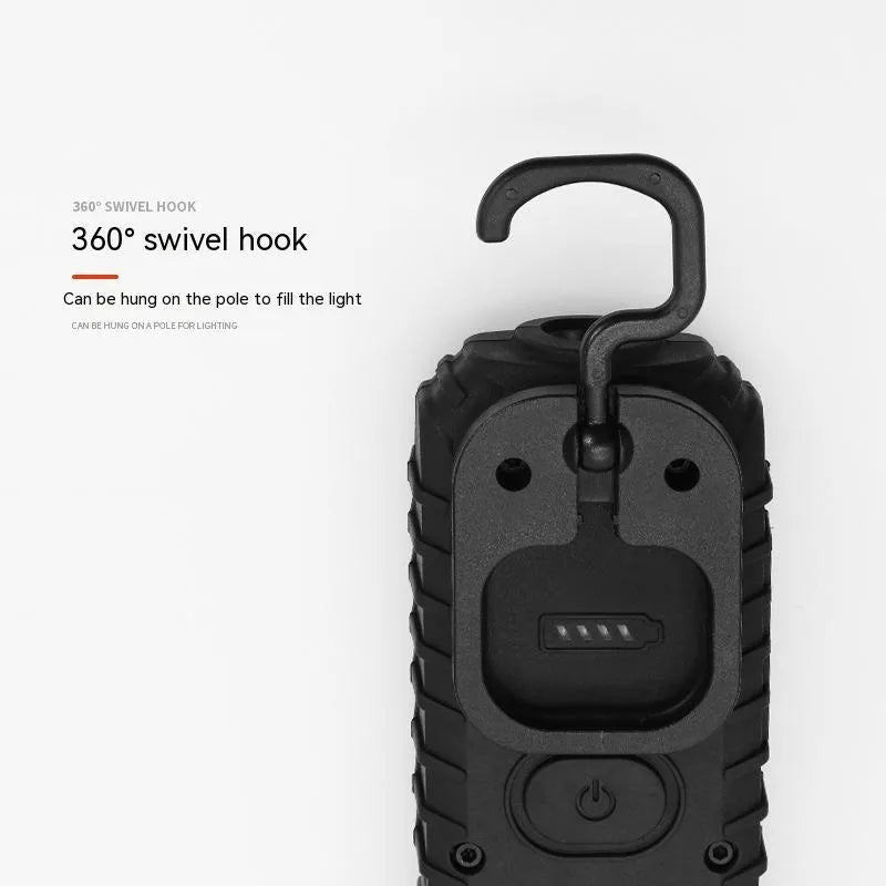 Black and green auto repair work light with USB charging port and drop-resistant coating