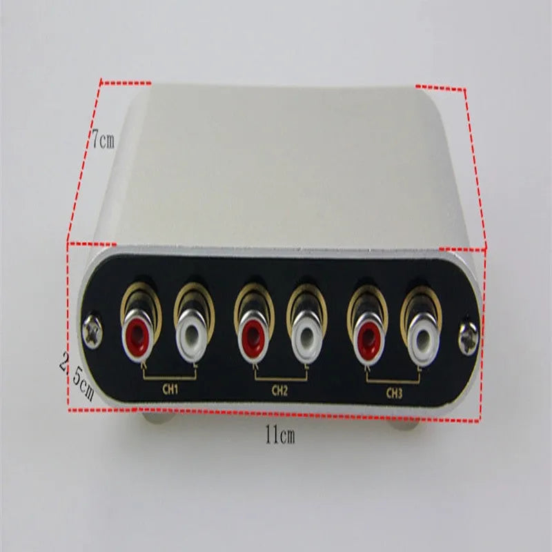 Silver audio source selector switch unit with infrared remote control for routing multiple audio signals.