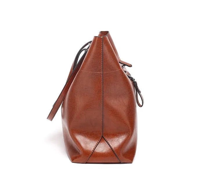 Brown wax cowhide cross-body leather handbag with two compartments showing internal mobile phone pouch.