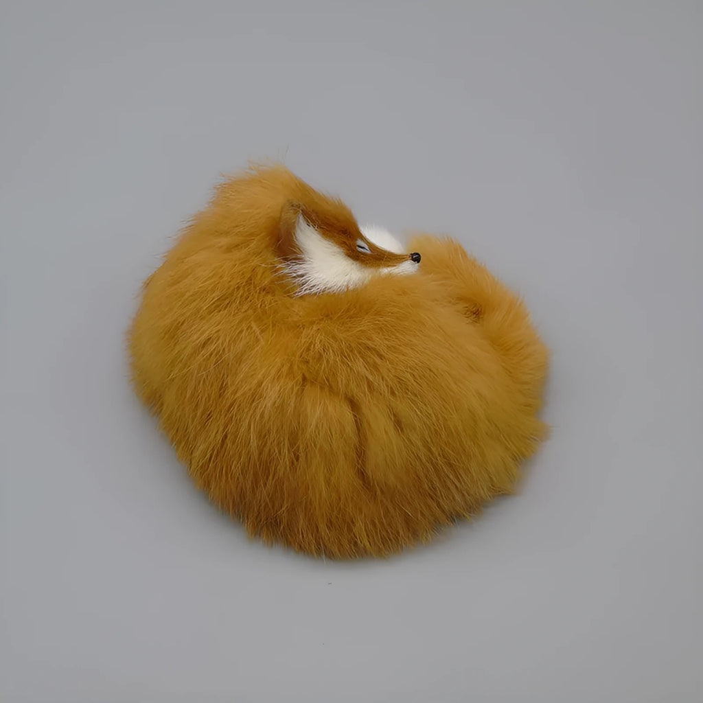 Artificial white fox fur car ornament measuring 15cm long on a car dashboard.