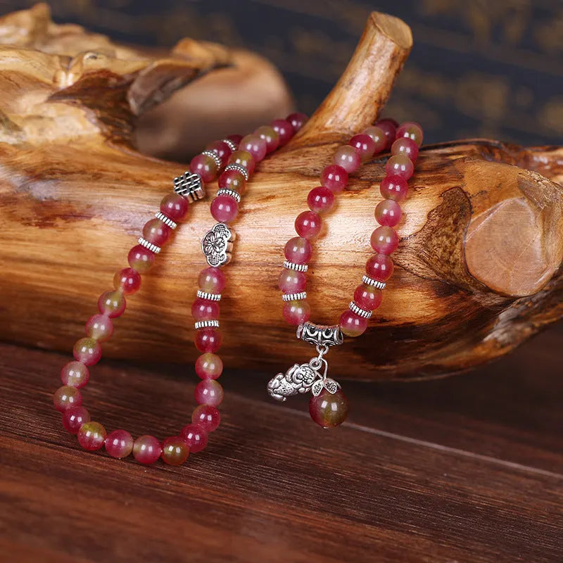 Handmade geometric bracelet made from natural watermelon crystal beads with Chinese knot closure.