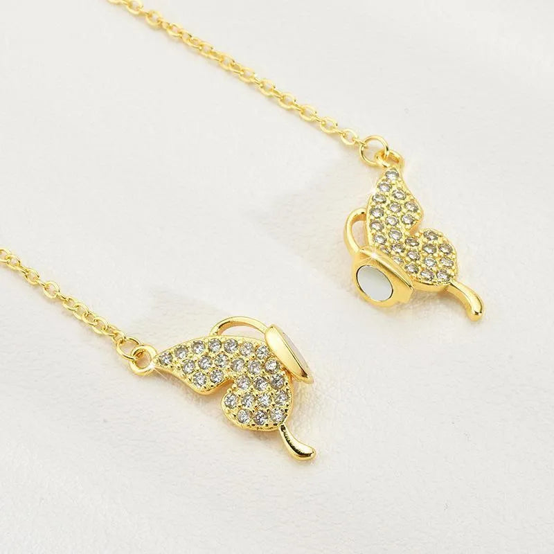 Women's gold and silver titanium steel clavicle chain with magnetic butterfly pendant on twisted chain.