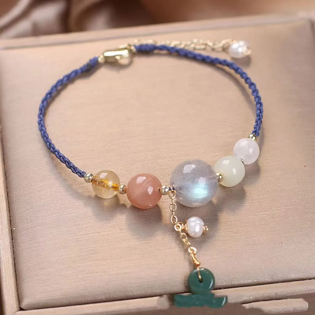 Hand-woven women's bracelet with a crystal buckle and sequins on blue string.