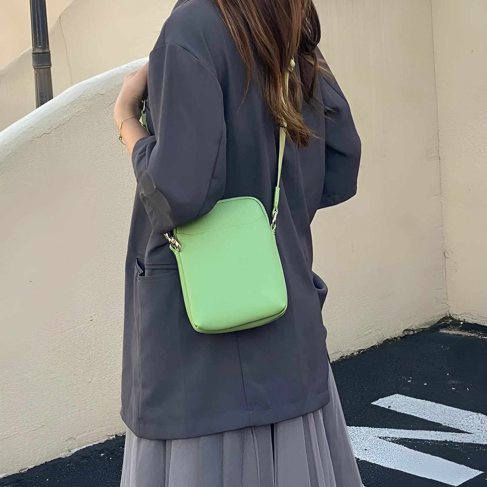 Solid colour PU leather mobile phone crossbody bag in beige showing shoulder strap and compact size