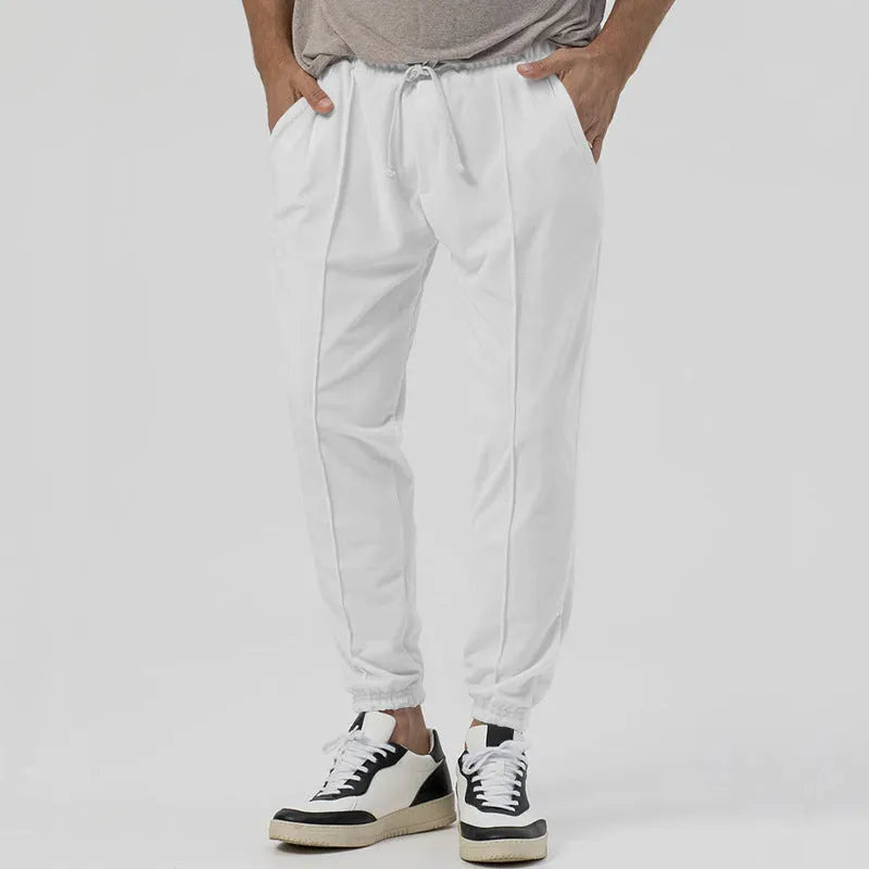 Men's grey tapered track sweatpants with straight-leg design and elastic waistband
