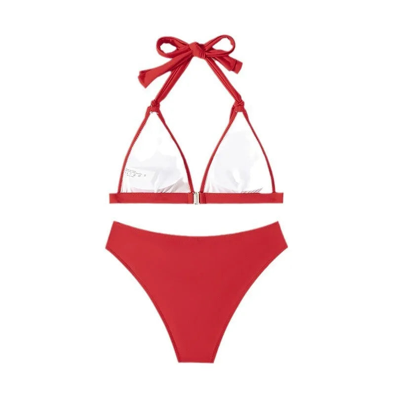 Red women's lace-up halterneck bikini with split shorts for beach swimming