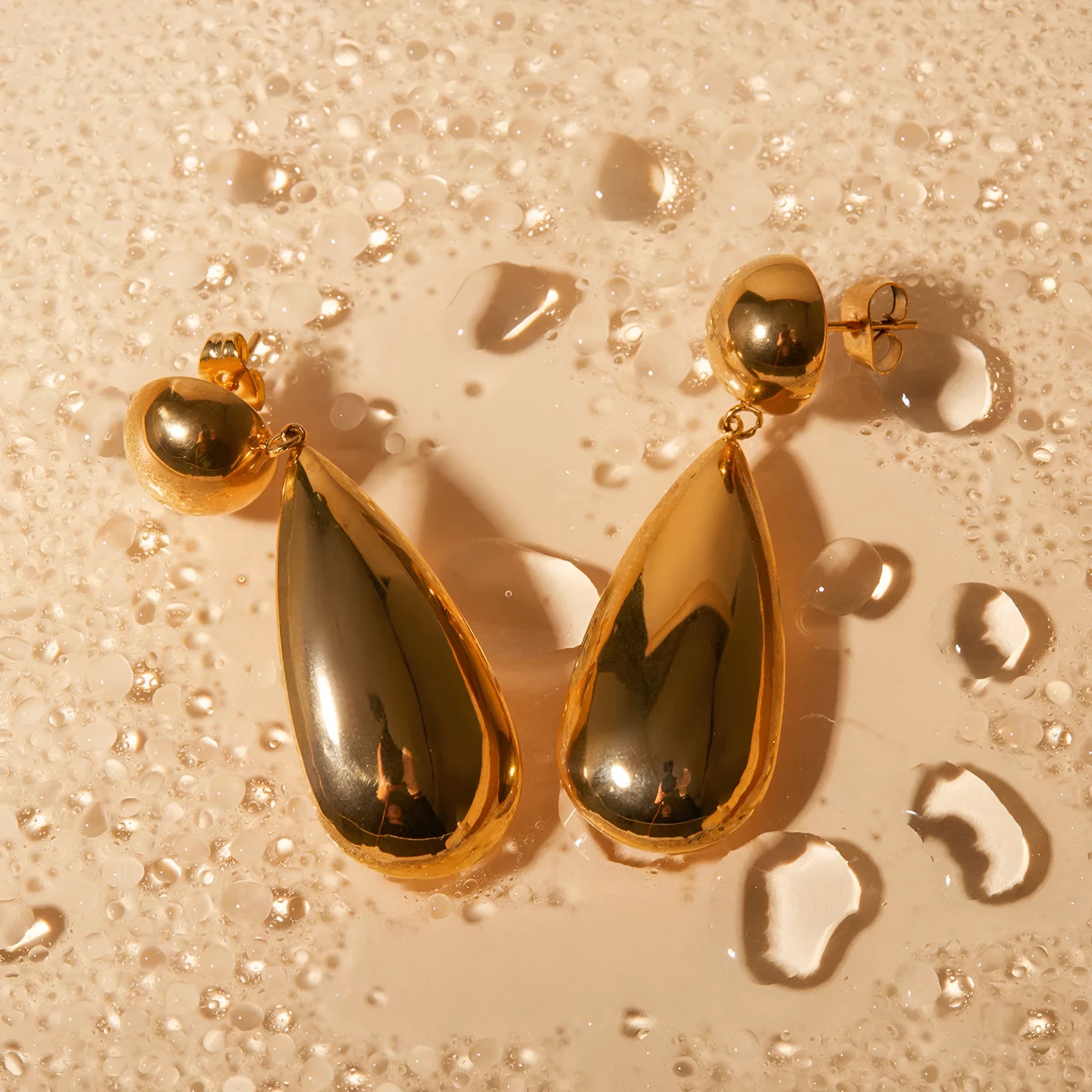 Gold hemisphere water drop pendant earrings with geometric design and electroplated finish