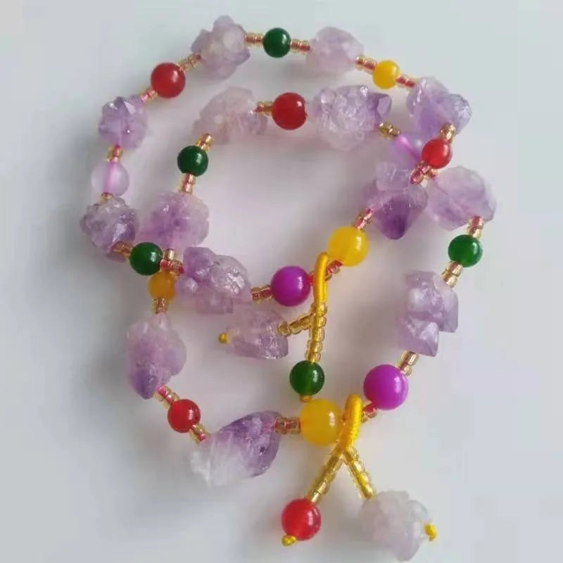 A natural style women's bracelet made with amethyst-shaped beads and a decorative fu character.