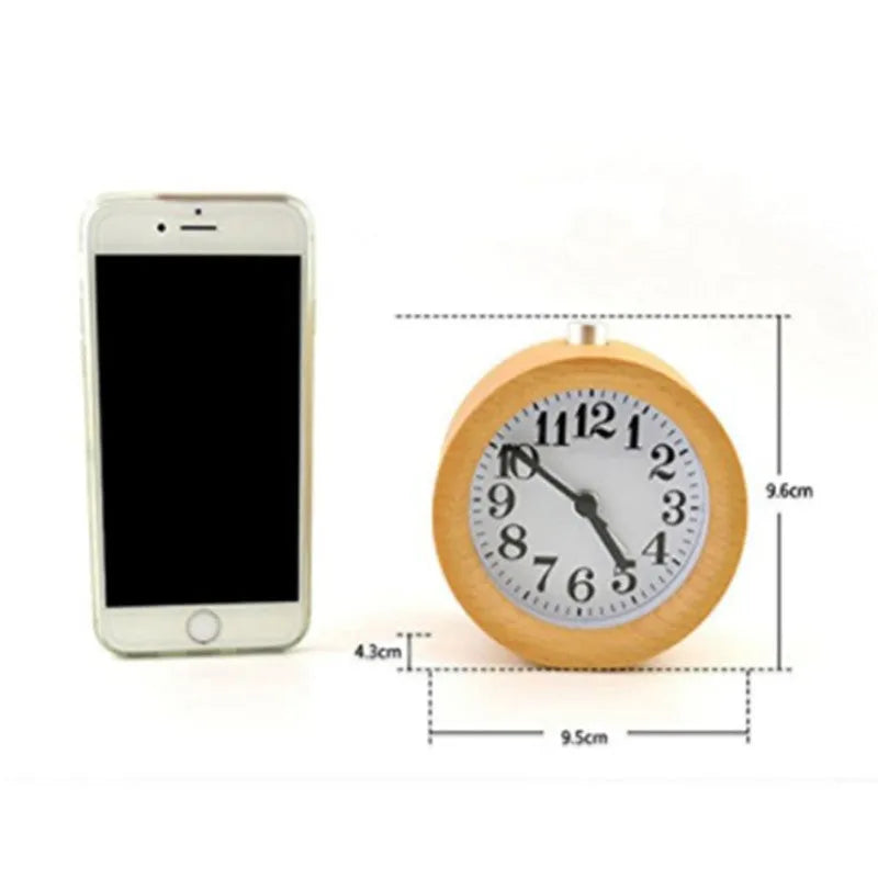 Solid beech wood square alarm clock with traditional analogue dial on wooden surface