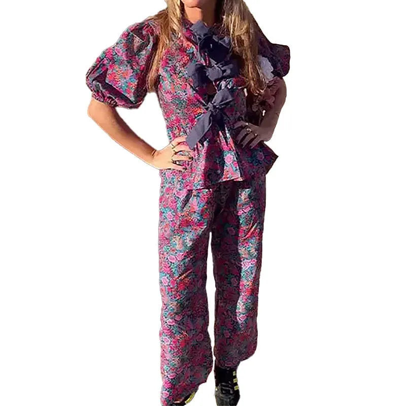 Women's floral print trouser suit co-ord set with puff sleeve top and matching trousers.
