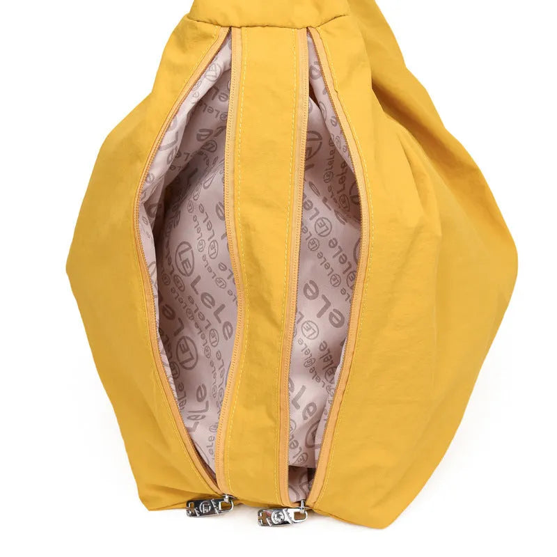 Soft nylon women's underarm bag in a heart shape, shown in black, blue, khaki, and yellow colours.