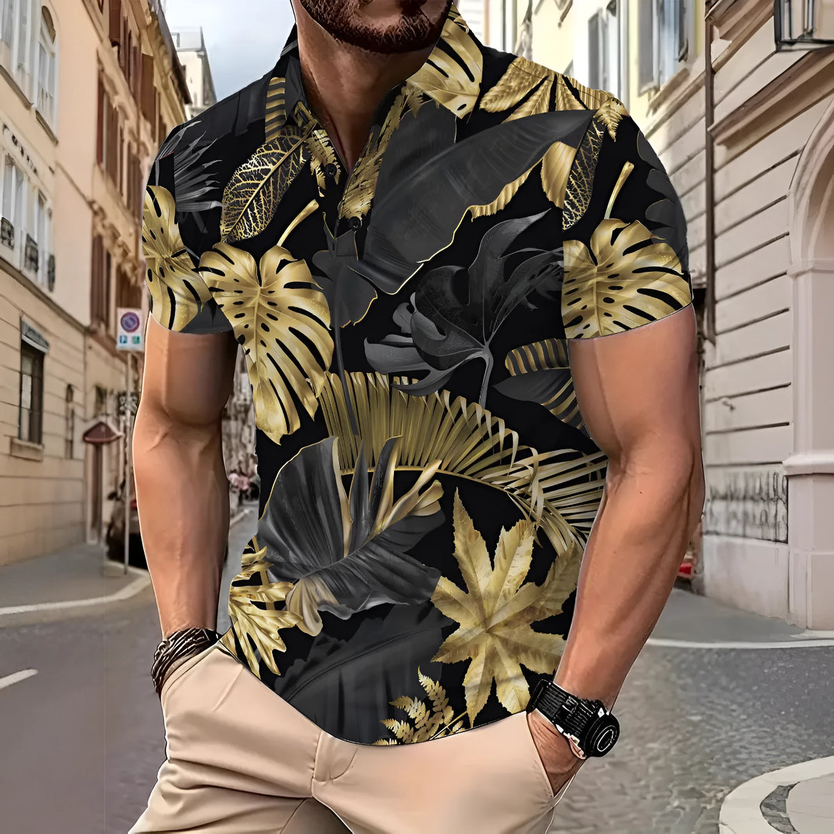 Man wearing a gold short sleeve shirt with a tropical leaf pattern print