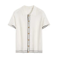 White short sleeve women's cardigan with dark contrast lapels, laid flat.