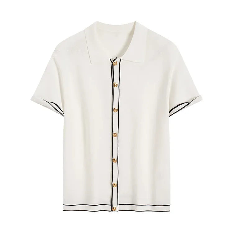 White short sleeve women's cardigan with dark contrast lapels, laid flat.