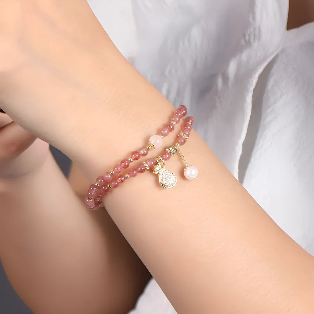 Women's strawberry quartz crystal bracelet with geometric design on wrist