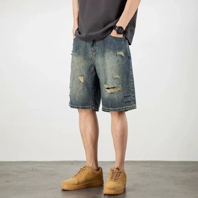 Man wearing blue retro-style loose denim shorts with a straight leg cut.