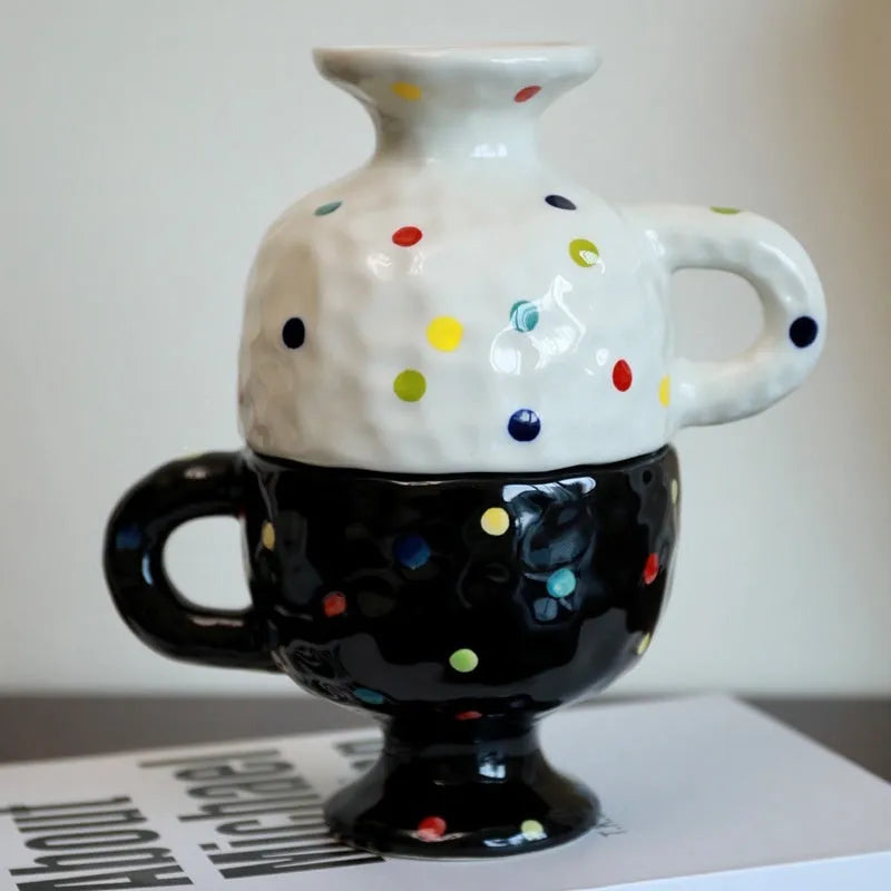 Hand-pinched irregular shaped ceramic mug in a solid colour, shown on a surface.