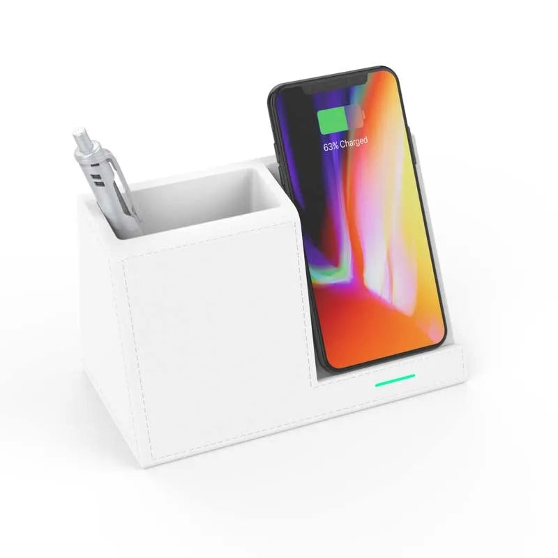 Black leather wireless charging station with built-in pen holder on a wooden desk.