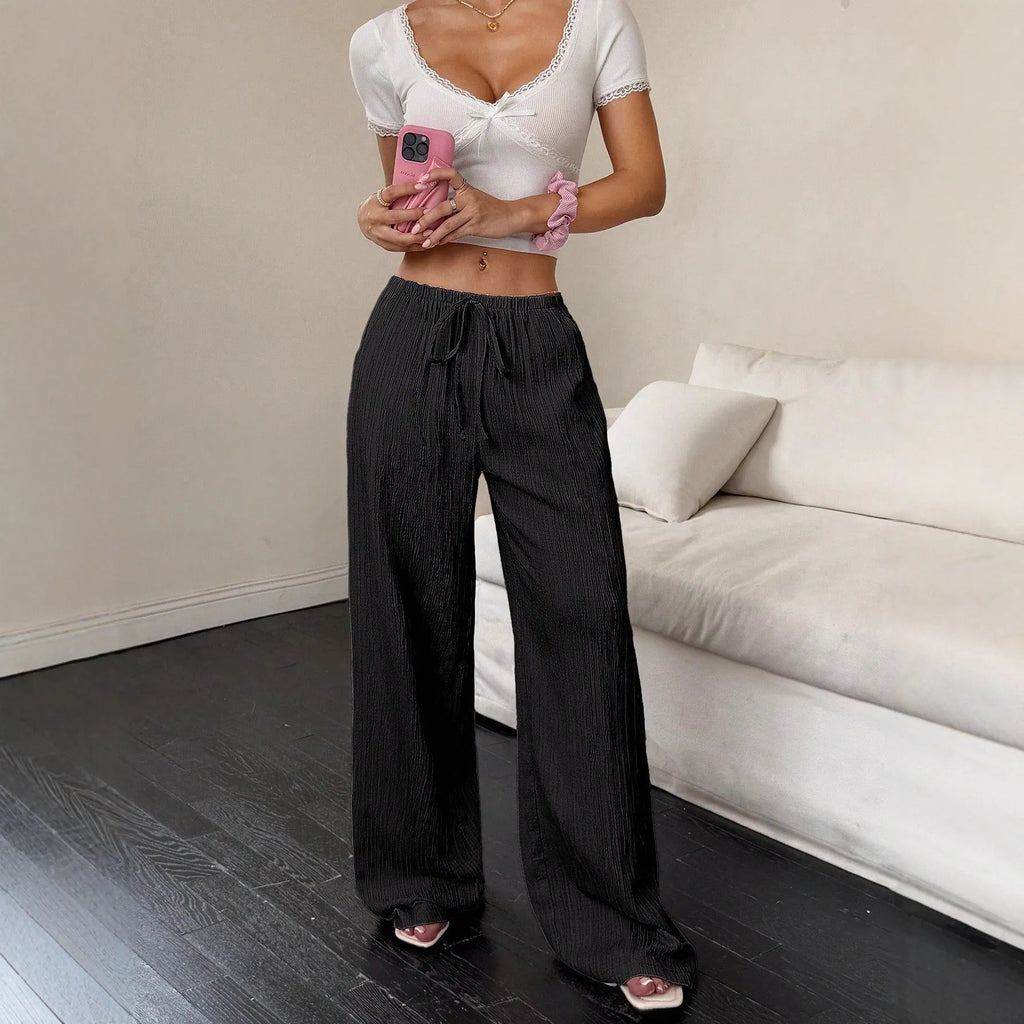 Women's black wide-leg trousers with lace-up waist trimming detail showing front view